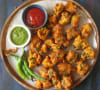 Pakoras with vegetables and yogurt sauce
